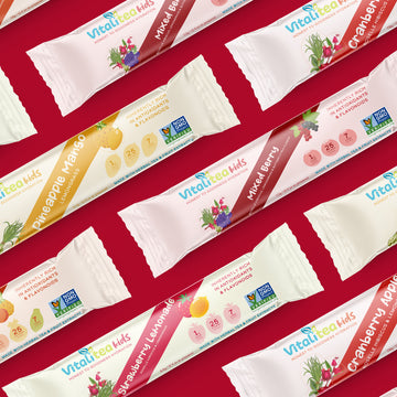 Variety of Vitalitea kids herbal flavor stickpacks showing the products all natural and healthy ingredients